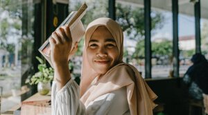 A person with a book on their hands